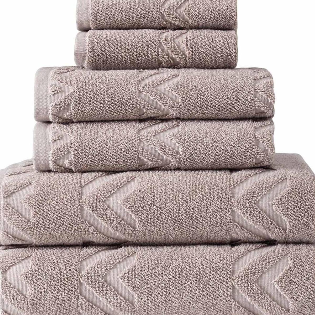 Stack of Turkish cotton towels, taupe with raised chevron-style geometric pattern
