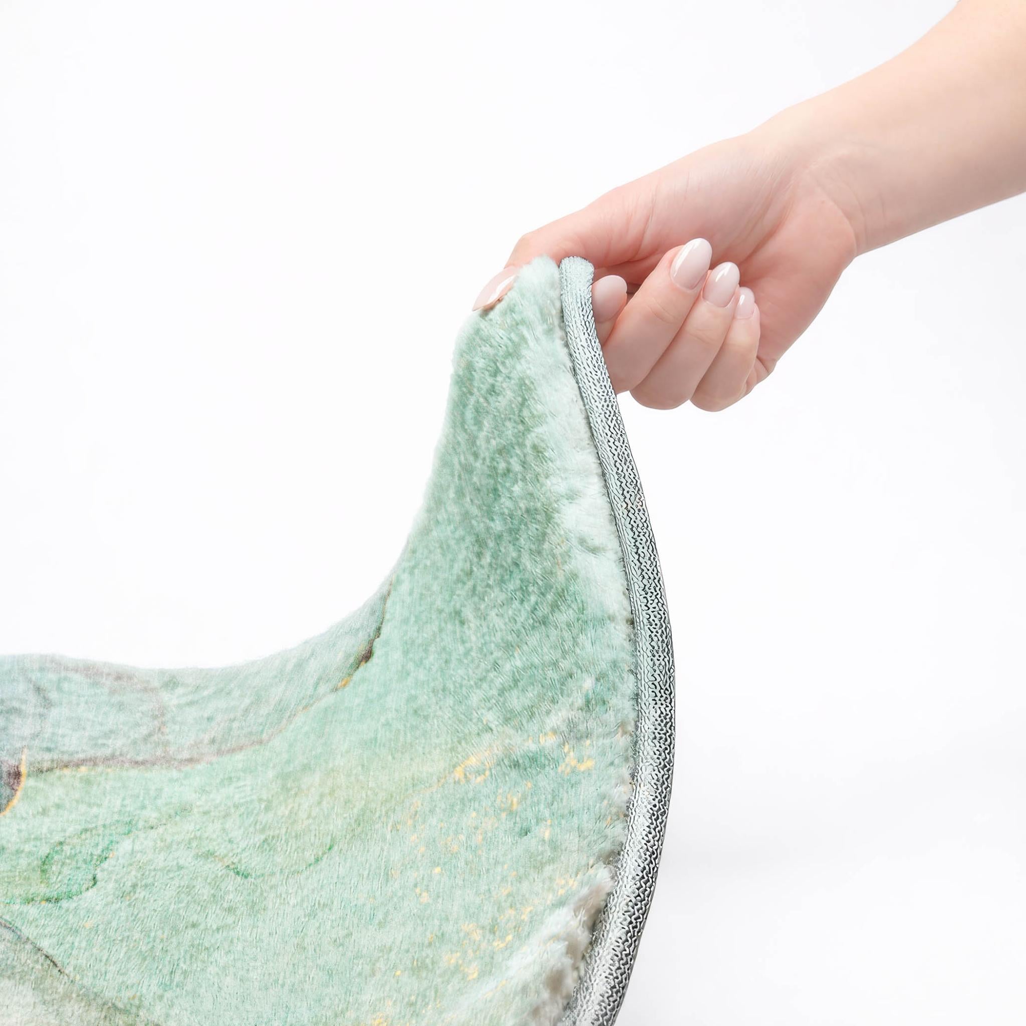 Teal and blue abstract shag rug edge with gray binding