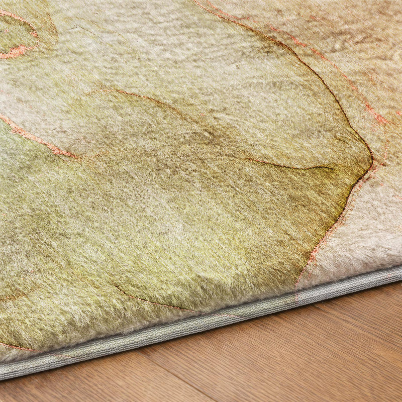 Corner close-up of light beige shag area rug with green abstract lines and gray edge binding