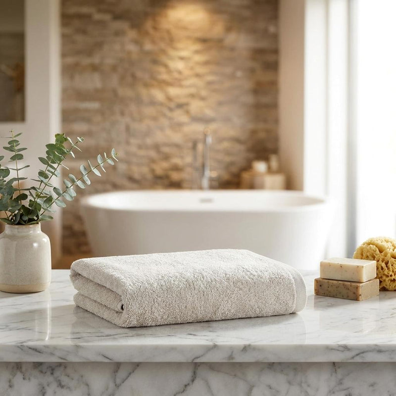 Beige Turkish cotton bath towel, neatly folded with textured terry surface