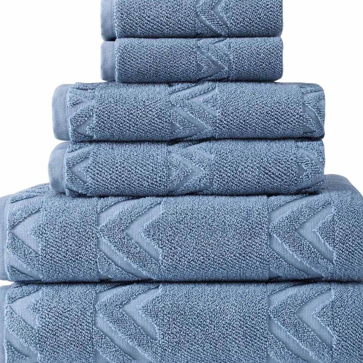 Stacked blue geometric towels with chevron pattern on textured terry