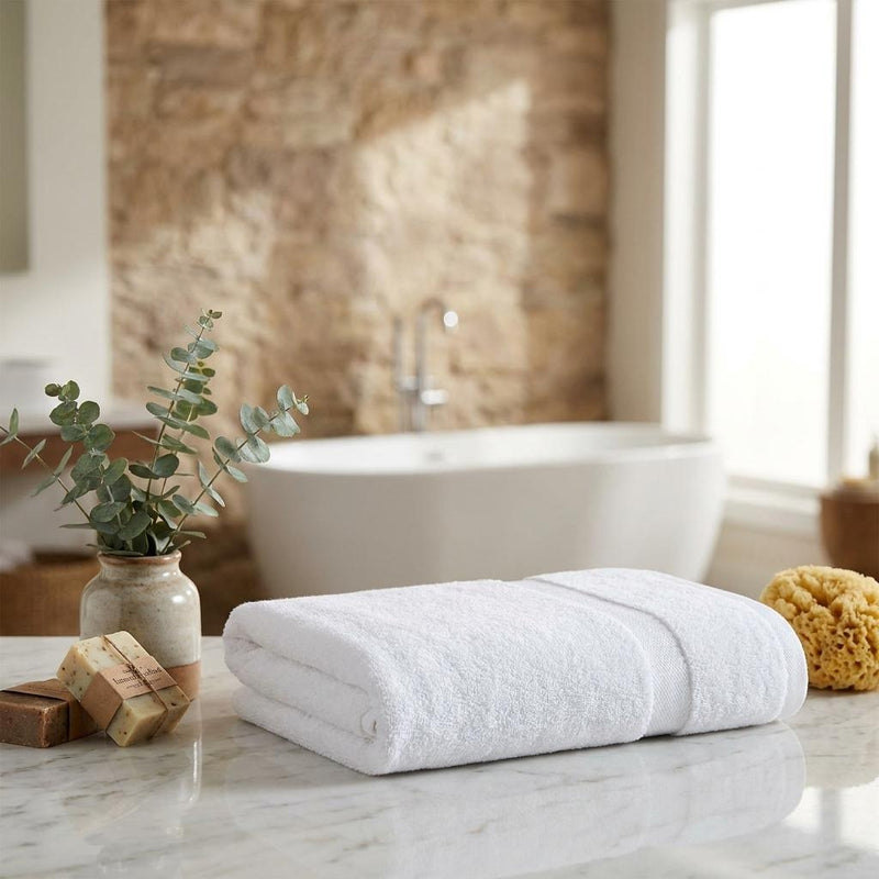Set of two white bath towels, rolled and stacked