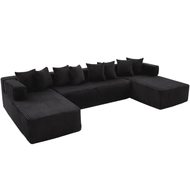 Dark corduroy U-shaped sectional with chaise ottomans, curved armrests, and stacked pillows