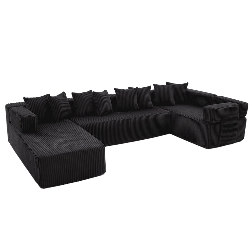 Dark corduroy corner sectional with low chaise seats and back cushions, featuring throw pillows