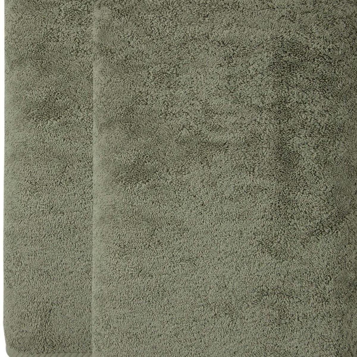 Green Turkish cotton bath sheet close-up, plush terry texture