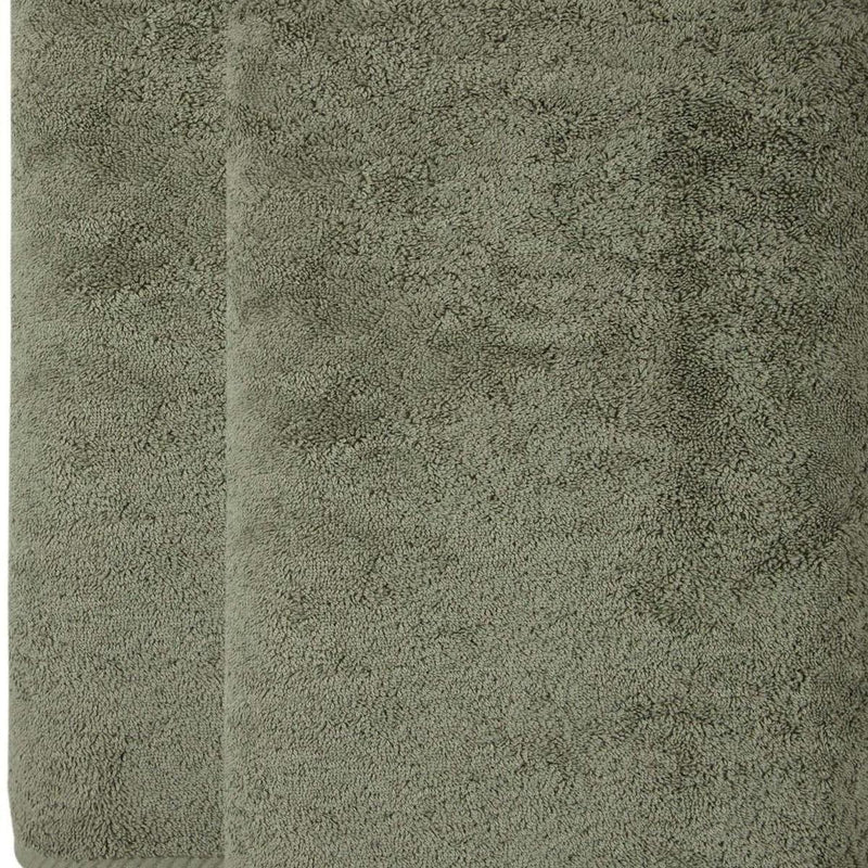 Green Turkish cotton bath sheet close-up, plush terry texture
