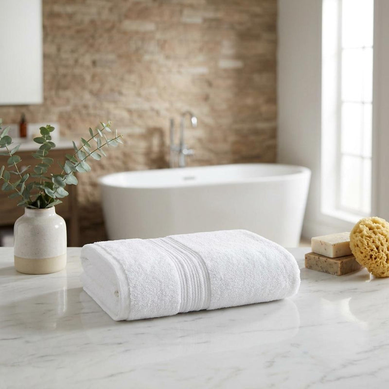 White bath towel set of two, rolled towels on bathroom countertop
