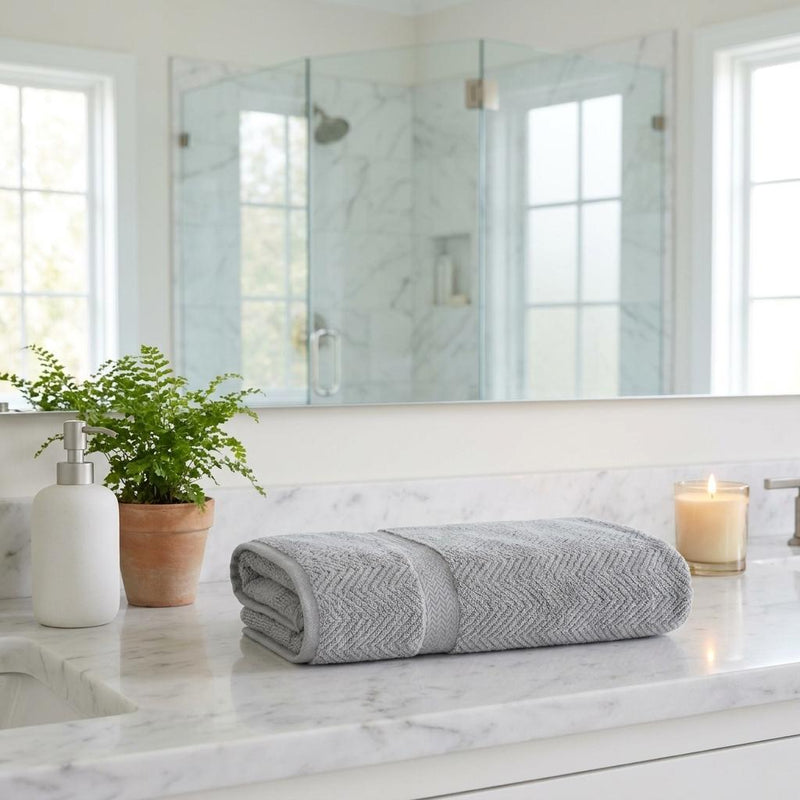 Light gray chevron Turkish cotton bath sheet, rolled for display