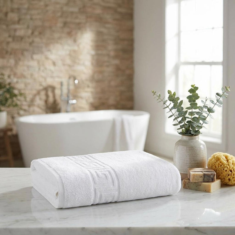 White bath towel with Greek key border, neatly folded
