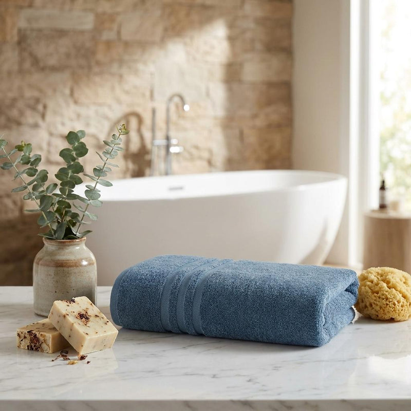 Aqua blue bath towel folded with horizontal striped bands, plush terry
