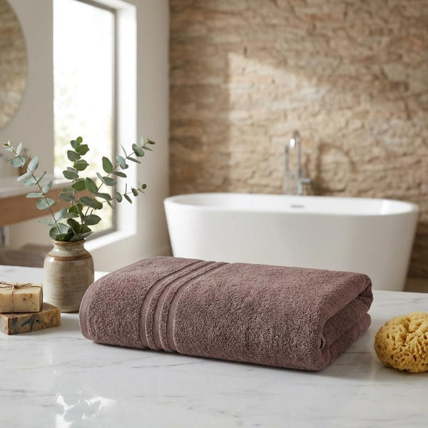 Set of two mauve Turkish cotton bath towels, folded with striped terry bands