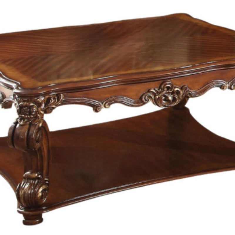 Brown wood coffee table corner with carved leg detail and arched apron trim