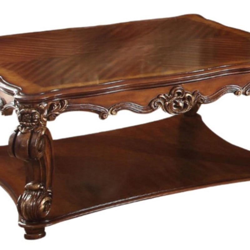 Brown wood coffee table side view with carved apron detailing and curved base legs