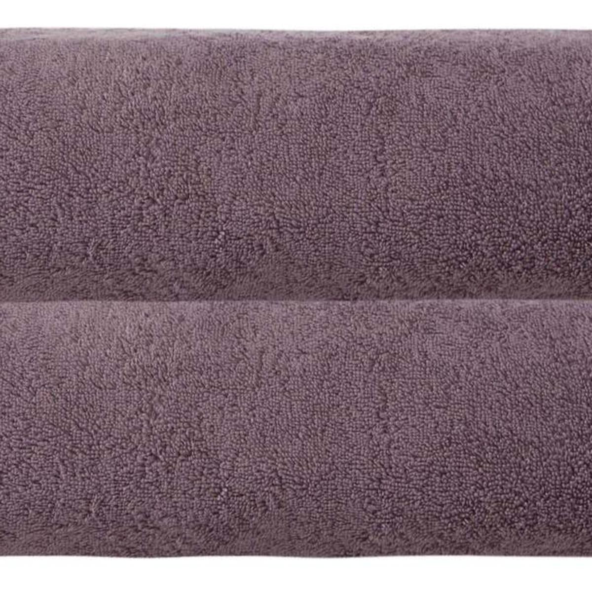 Close-up of purple terry bath sheet fabric with dense looped texture.
