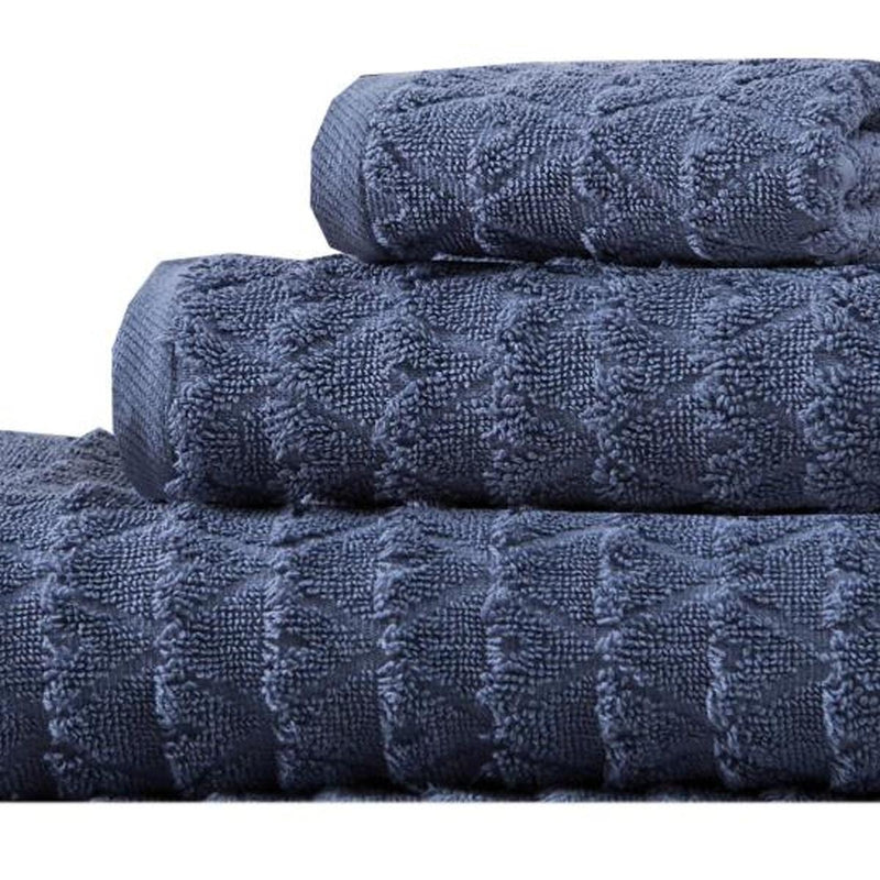 Navy geometric Turkish cotton towel stack, close-up of textured pattern