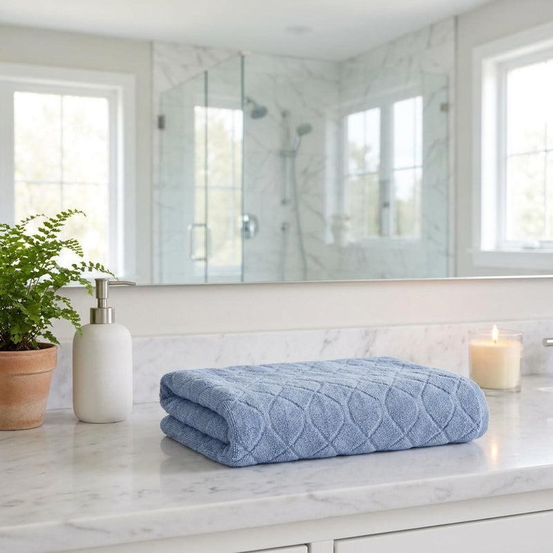 Navy blue Turkish cotton geometric bath towels, folded stack on countertop