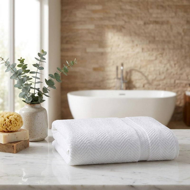 Folded white chevron Turkish cotton bath sheet, plush towel with stitched edge