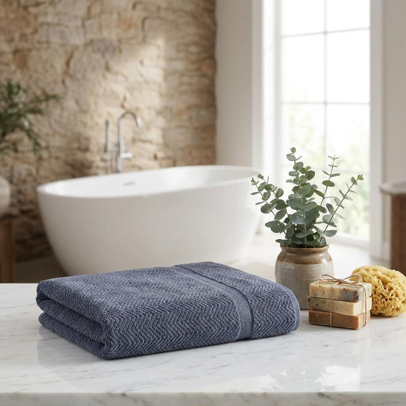 Light gray chevron Turkish cotton bath sheet folded on bathroom counter