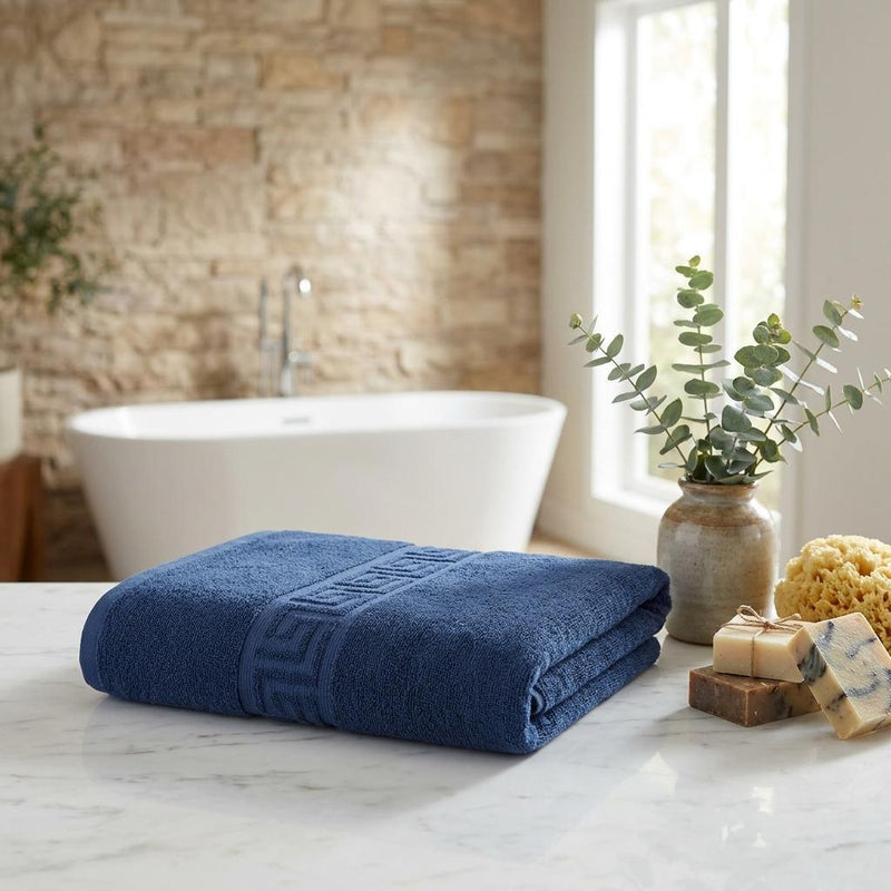 Navy Turkish cotton hand towel with Greek key stripe, rolled and folded