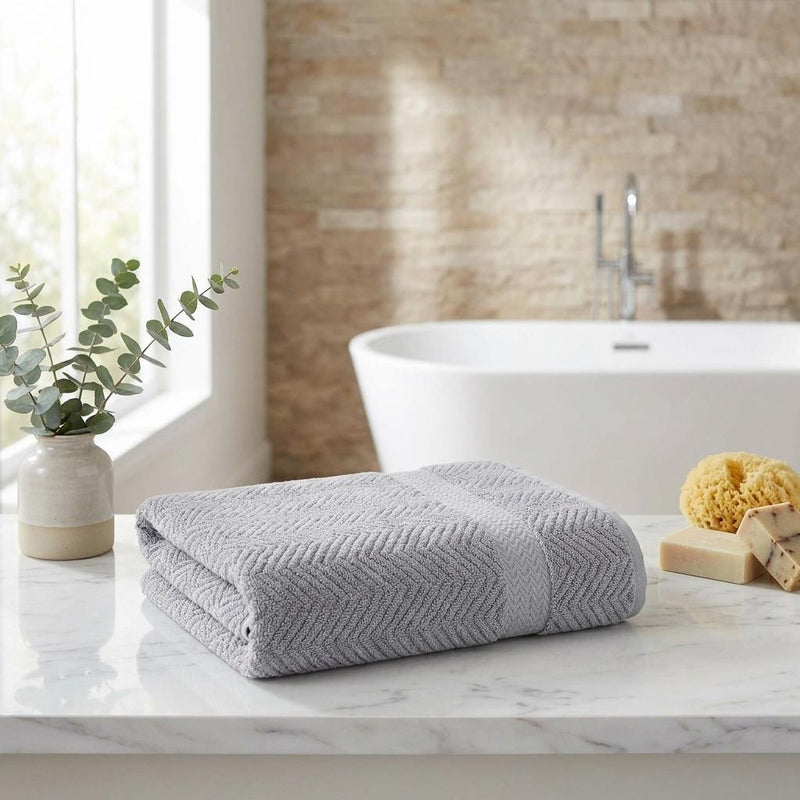 Gray Turkish cotton bath towel with chevron pattern, neatly folded