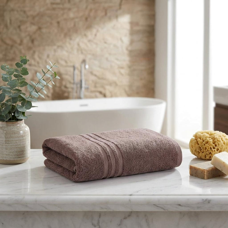 Pair of brown terry bath towels folded with matching horizontal stripe borders