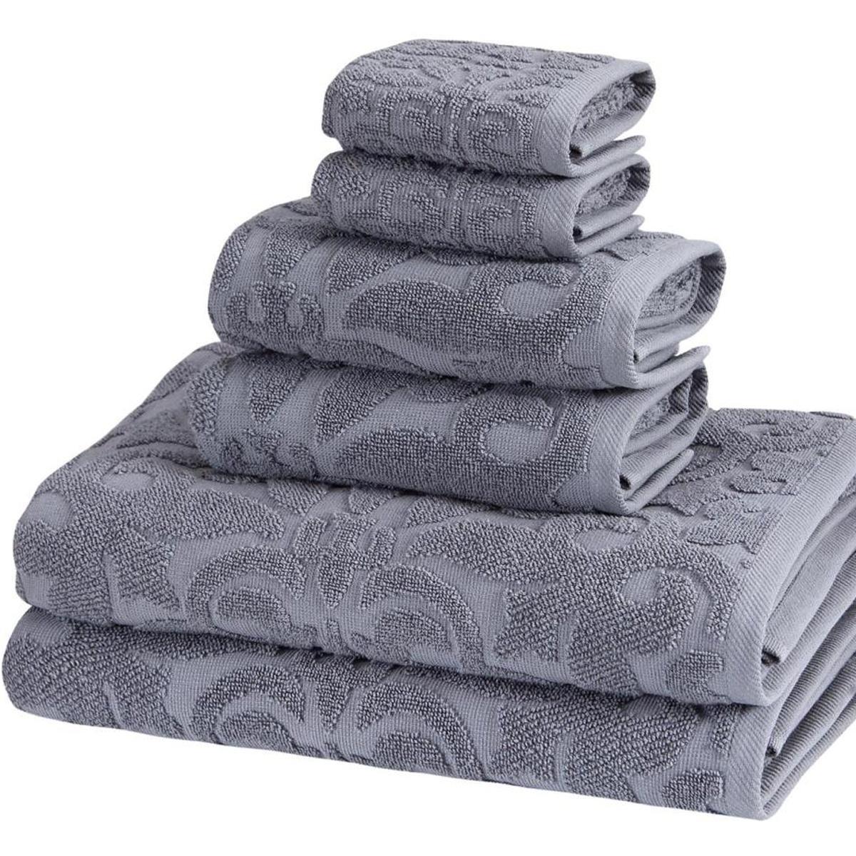 Light gray towel set with textured floral jacquard, neatly stacked in close view