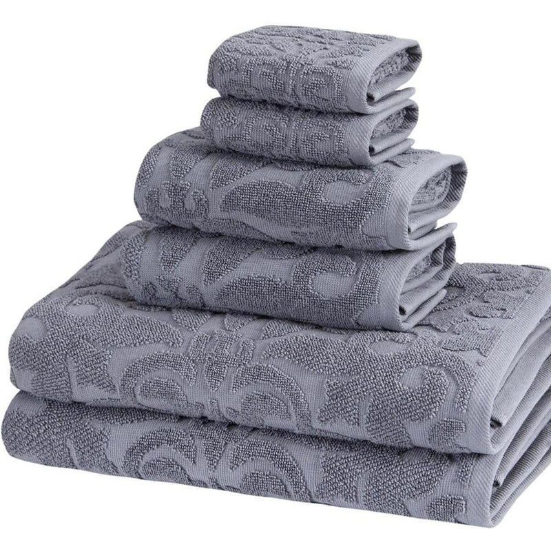 Light gray towel set with textured floral jacquard, neatly stacked in close view