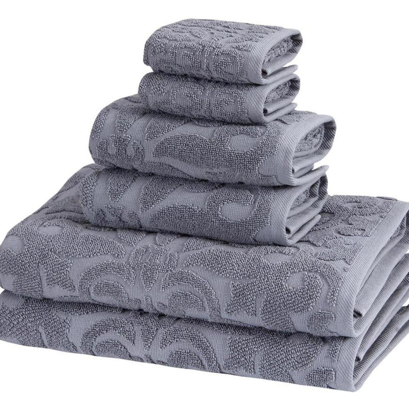 Light gray Turkish cotton towel set, stacked with large floral motifs and folded edges