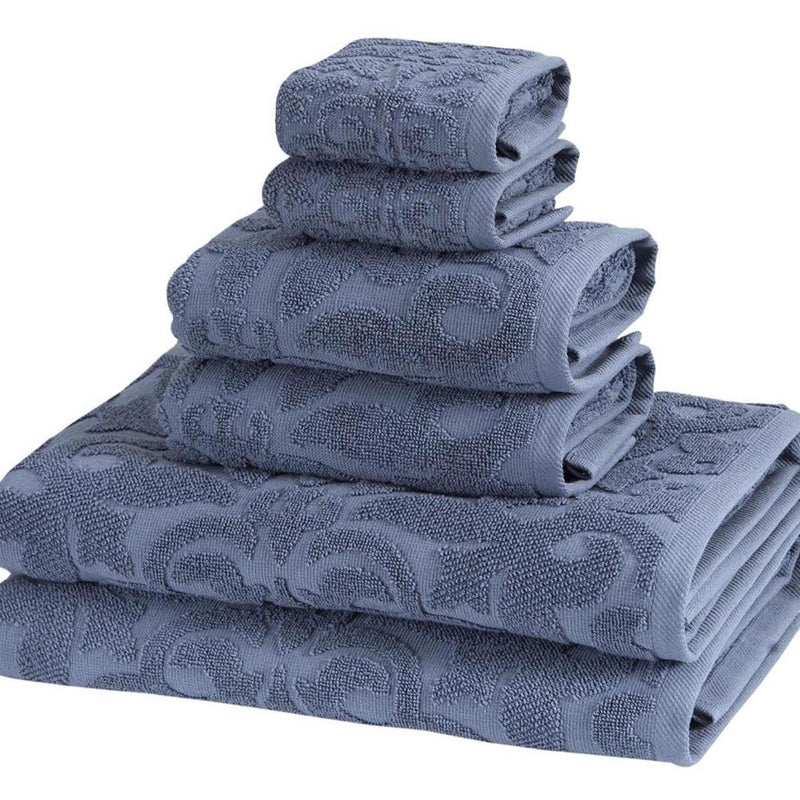 Blue Turkish cotton towel stack with floral jacquard pattern, folded edges visible
