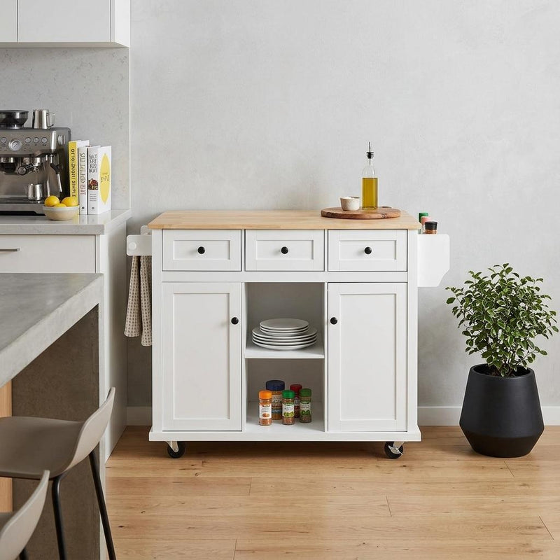 White kitchen cart with light wood top, drawers and cabinet storage, on rolling casters