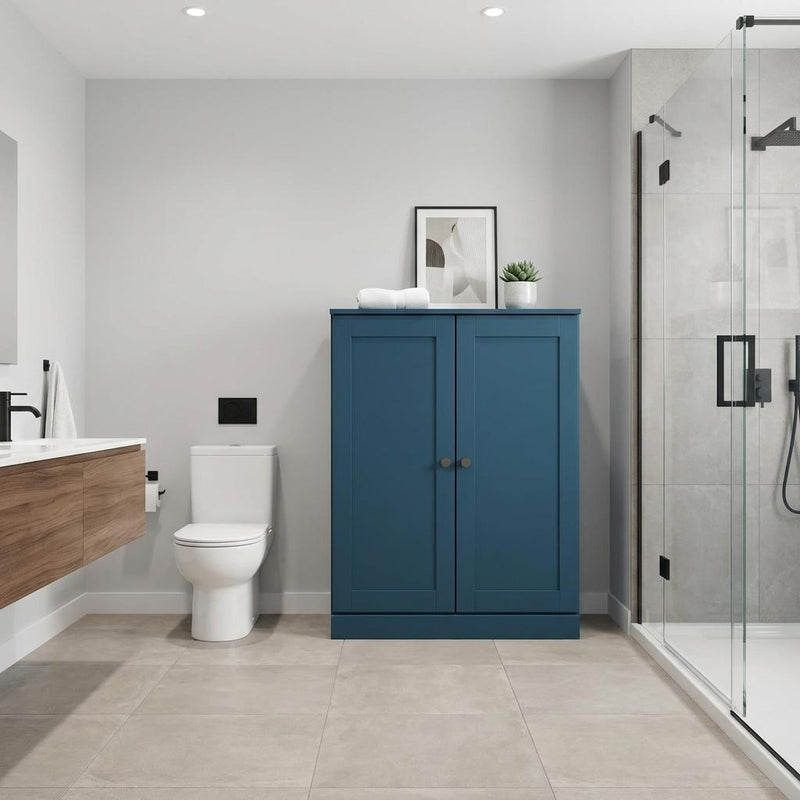 Teal blue double-door cabinet with round knobs and flat panels, top display items visible