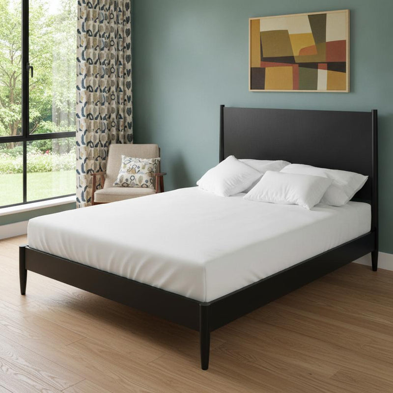 Black king bed frame with headboard and footboard, styled with white bedding and pillows.