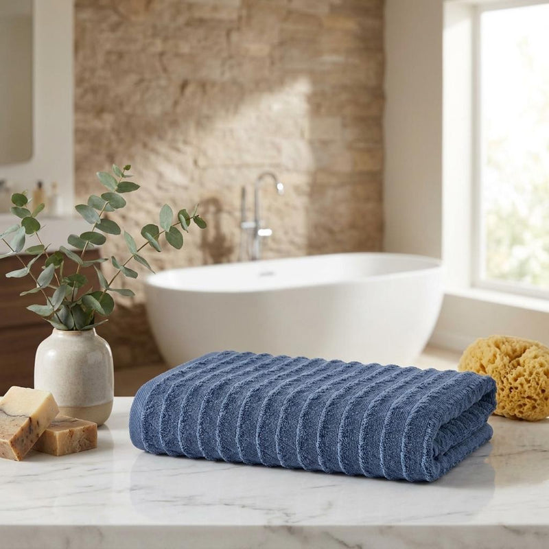 Navy geometric Turkish cotton bath towel set, folded on bathroom countertop