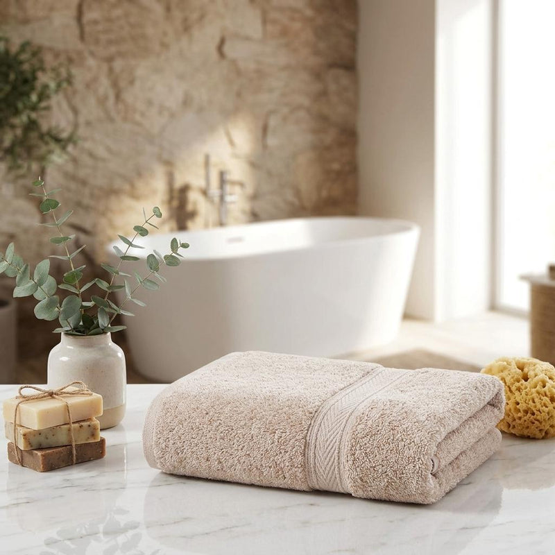 Set of two beige Turkish cotton hand towels, folded with decorative striped band