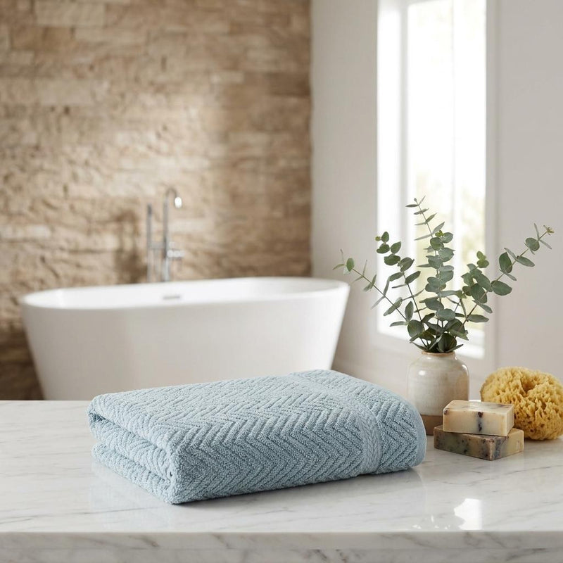 Aqua chevron Turkish cotton hand towel, folded on bathroom countertop