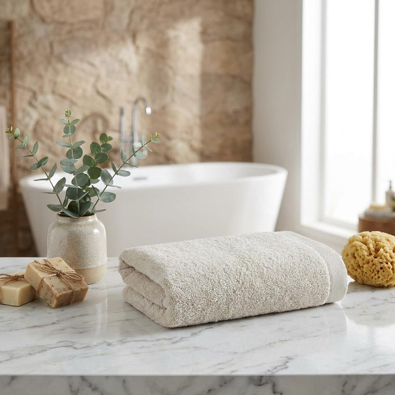 Beige Turkish cotton hand towels, folded and rolled, soft textured fabric