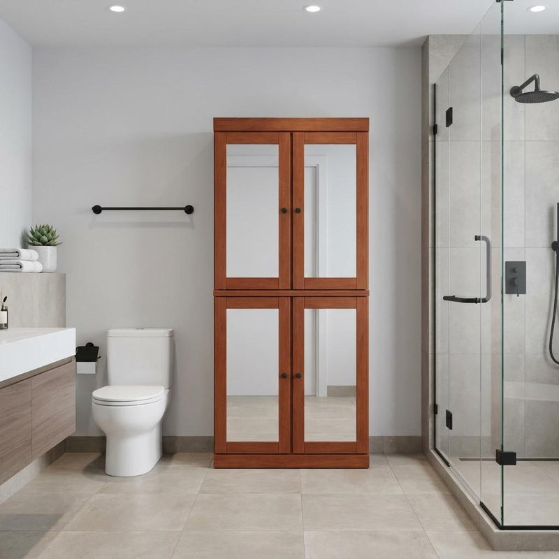 Double-door linen cabinet in warm wood with glass panels, shown in a bathroom setting.