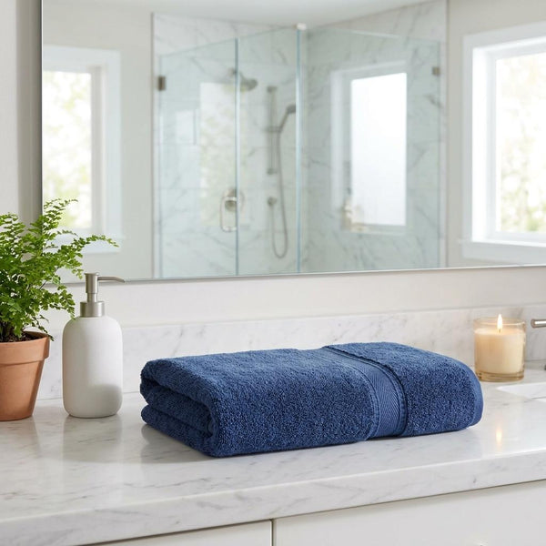 Set of two navy Turkish cotton bath sheets, folded with banded edge