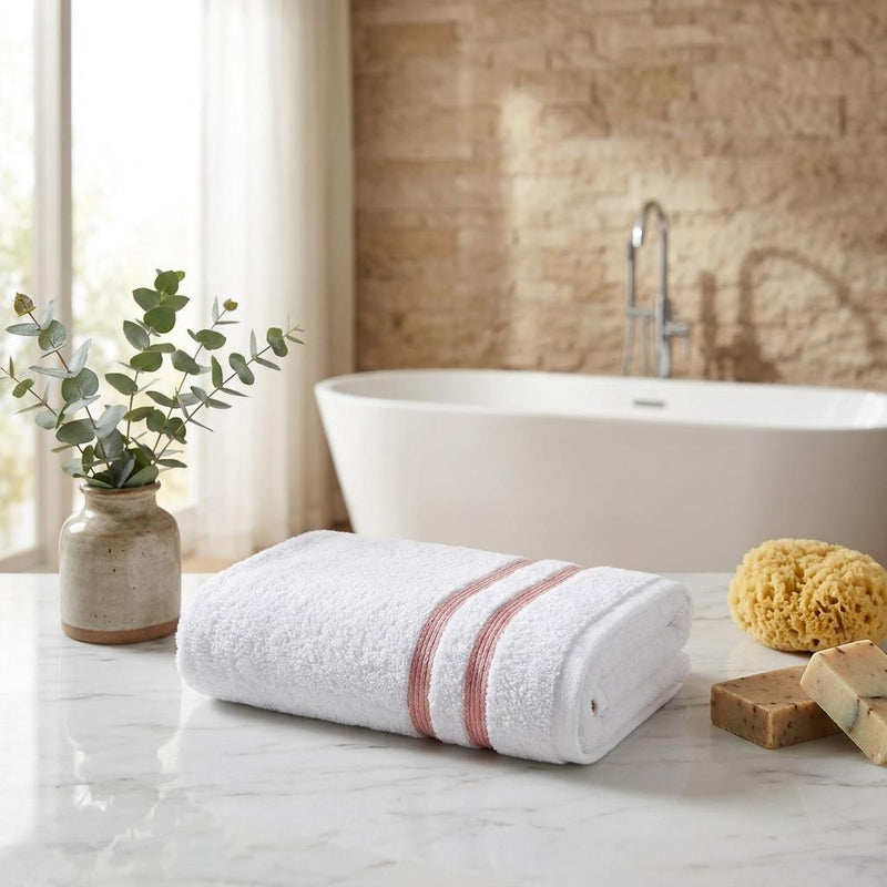 Two folded white hand towels with terracotta stripe trim, Turkish cotton terry