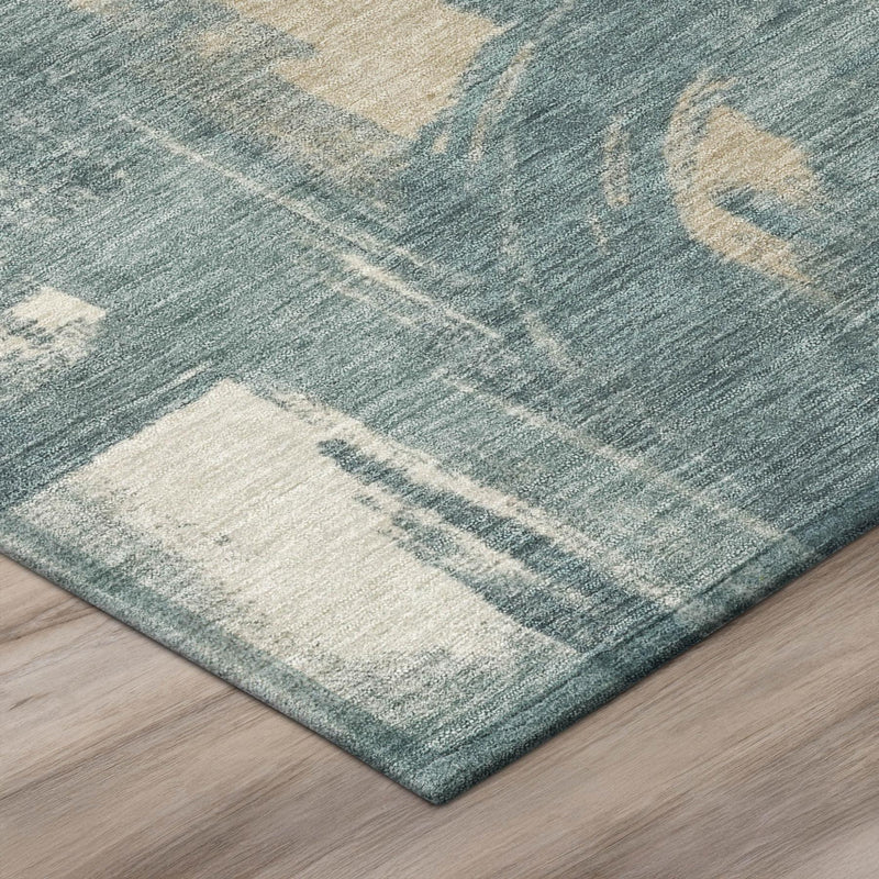 Corner view of round abstract rug in teal blue and light beige distressed pattern