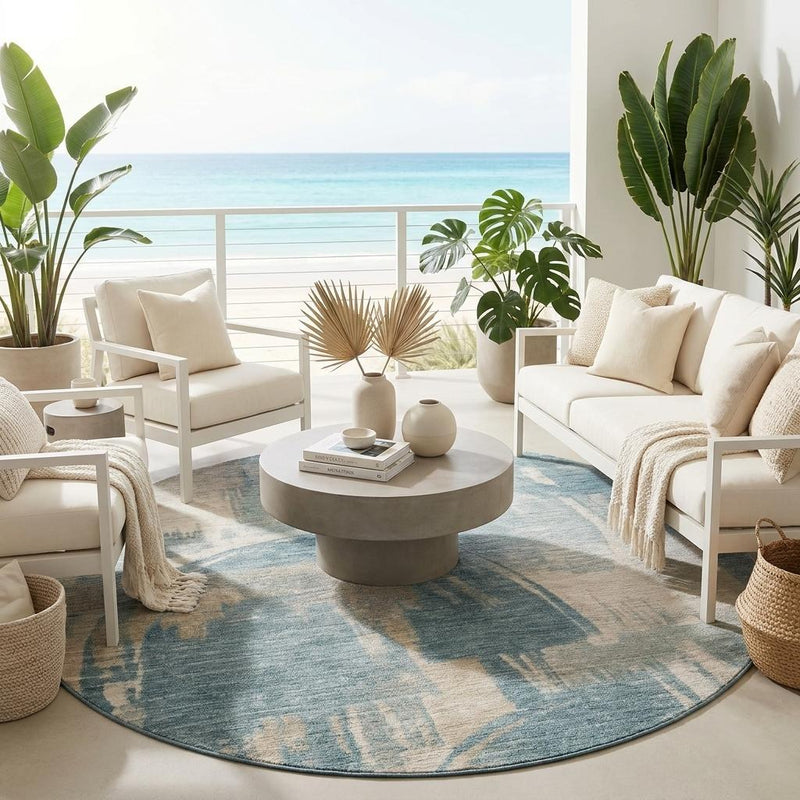 Round abstract indoor outdoor rug with teal blue and beige wash pattern