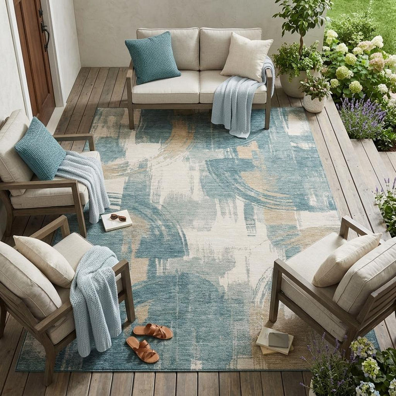 Indoor outdoor abstract area rug in blue, teal, and cream with distressed texture