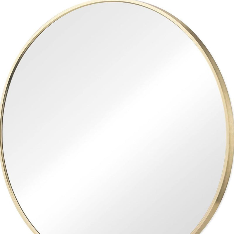 Round mirror with gold metal edge frame and clear reflective glass