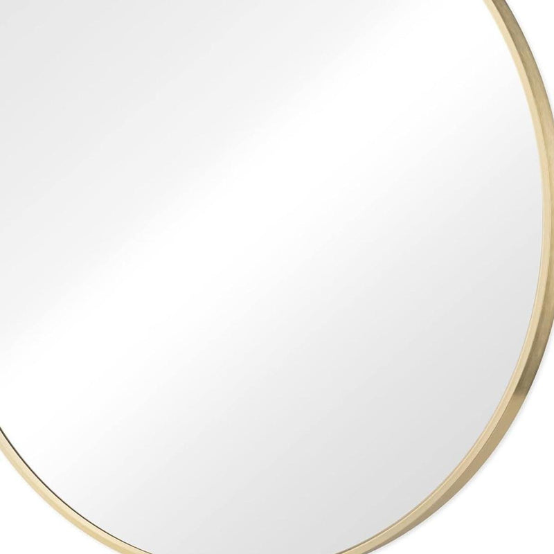 Gold metal-framed round mirror edge with smooth reflective surface