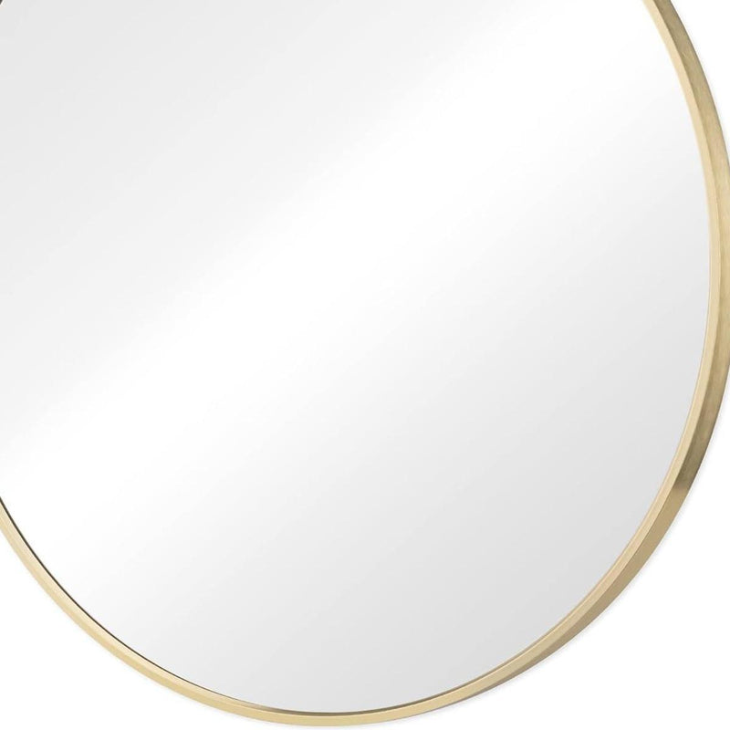 Round mirror with gold metal frame, close-up of bottom edge