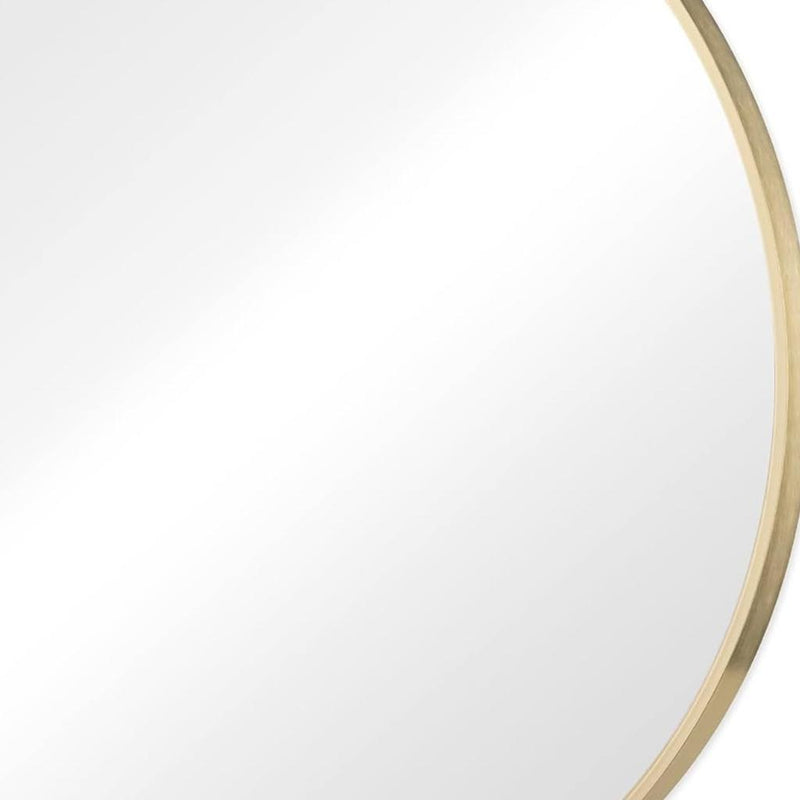 Gold metal framed round mirror, close-up of outer rim