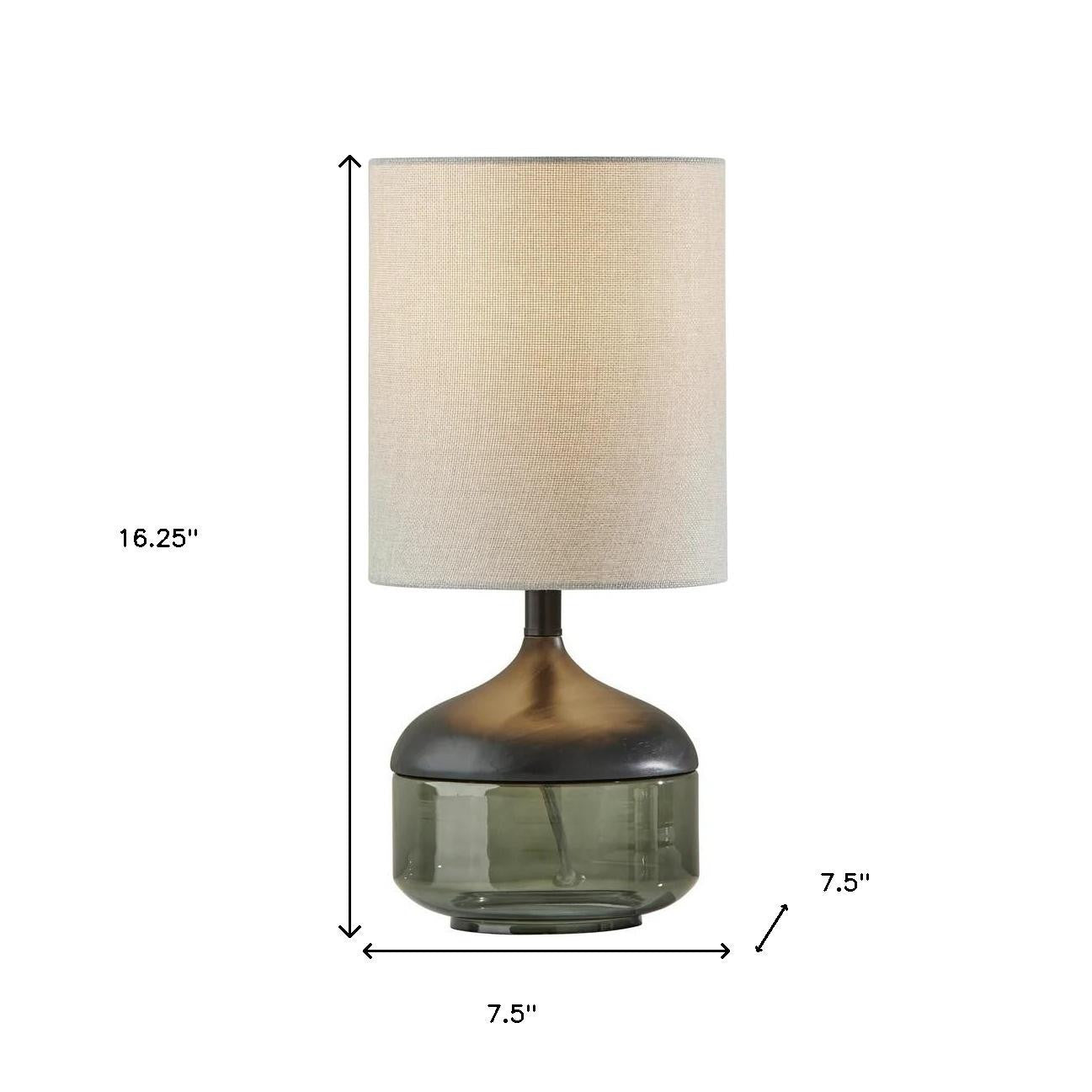 Elegant glass table lamp with a smoky gray base and beige fabric shade, measuring 16.25" tall.