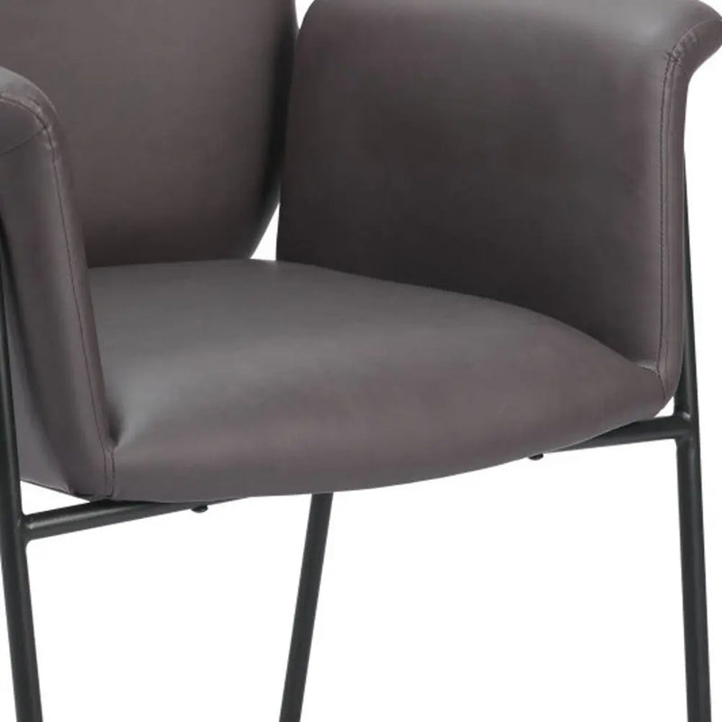 Contemporary gray leather dining chair with sleek black metal legs and ergonomic armrests.
