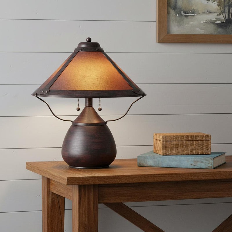 Rust-brown two-light metal table lamp with amber empire shade and two hanging pulls