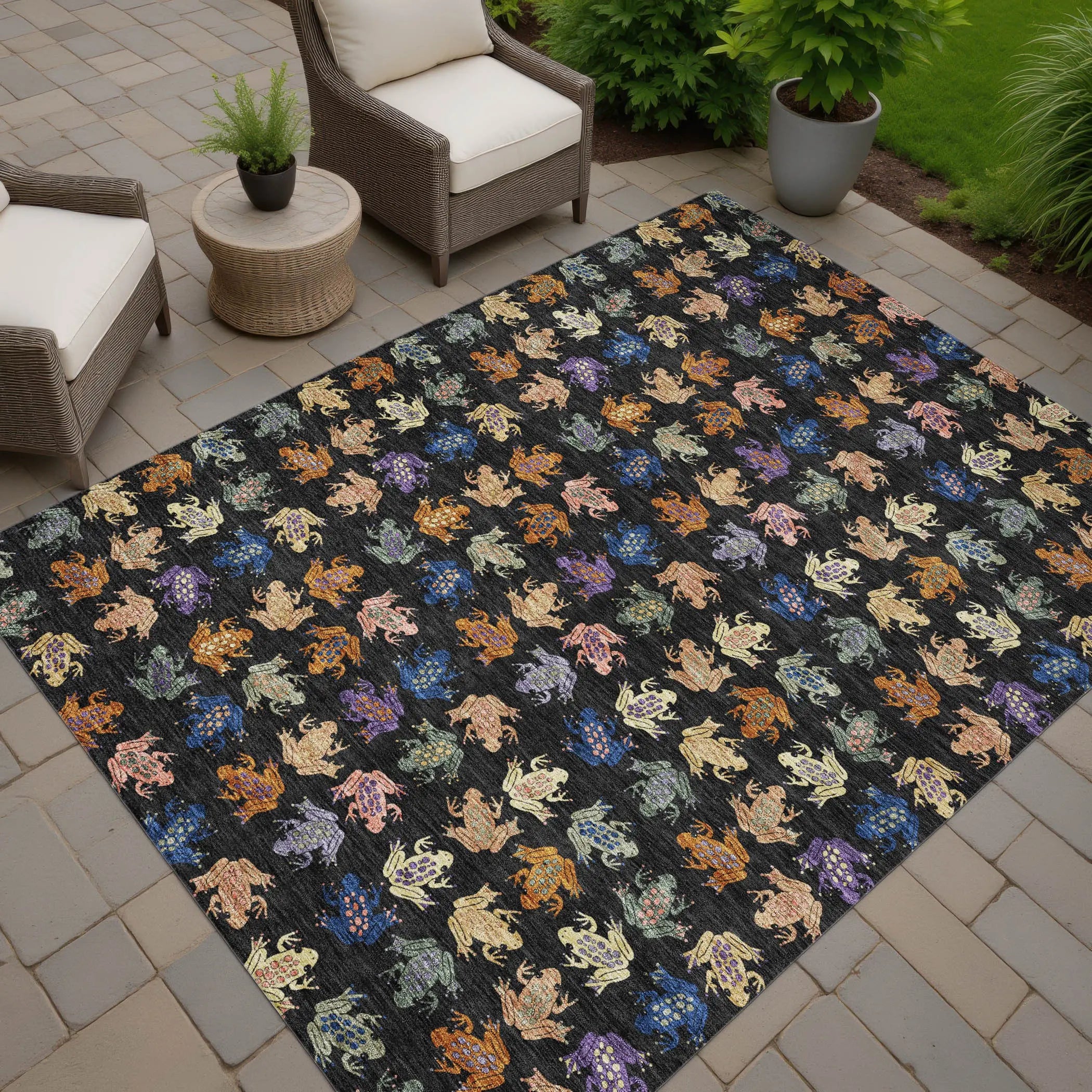 Vibrant outdoor rug featuring colorful frogs on a black background, perfect for patios and garden spaces.